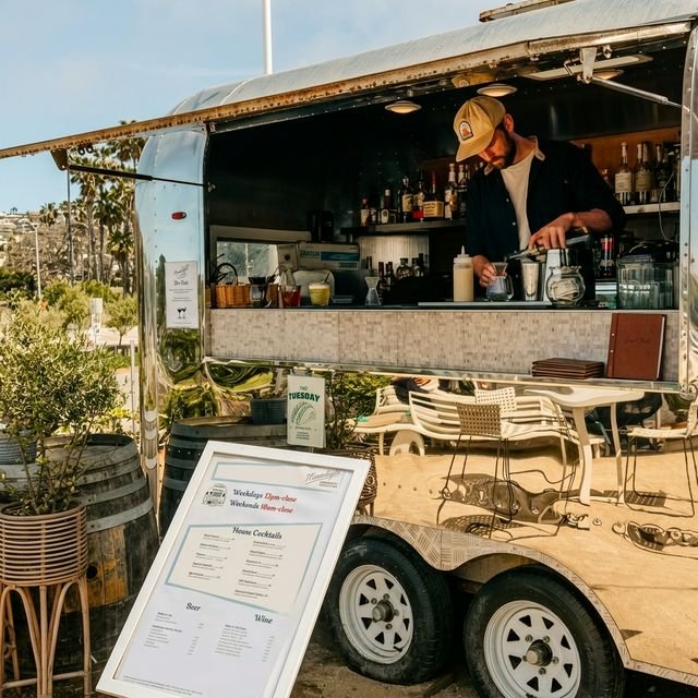 Bartender at the polished silver Moonlight cocktail trailer