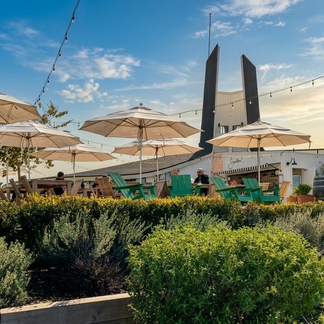 The Beach Club patio, umbrellas, and landmark tower
