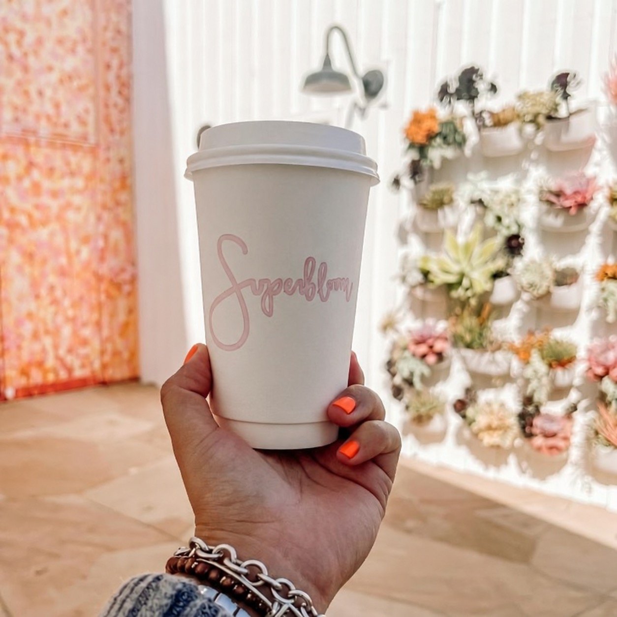 A Superbloom coffee cup outside the café